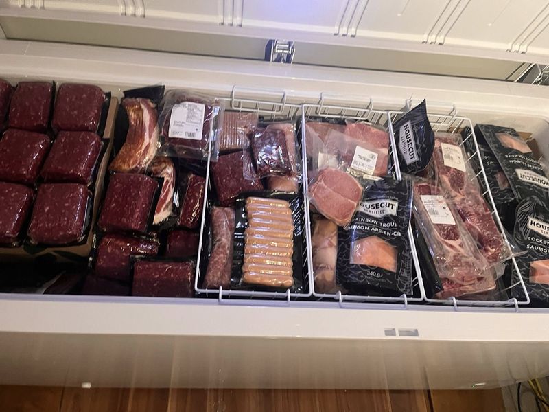 A freezer stocked full with a Shopease Foods delivery