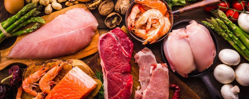 Salmon, shrimp and other fresh proteins laid out on a table